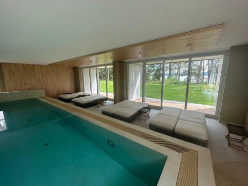 a swimming pool in a house with benches and sidx sidx sidx sidx at Wunderschönes Apartment Soul Space mit Seeblick im Marina Resort Bad Saarow in Bad Saarow