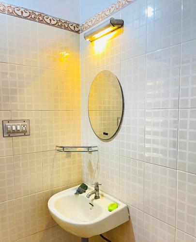 a bathroom with a sink and a mirror at Mangosteen villa in Cochin