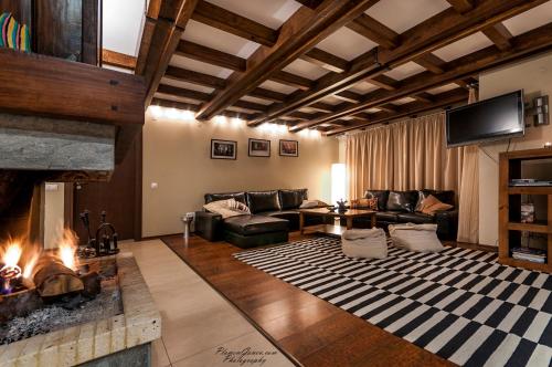 a living room with a couch and a fireplace at Villa Chalet Everest in Bansko