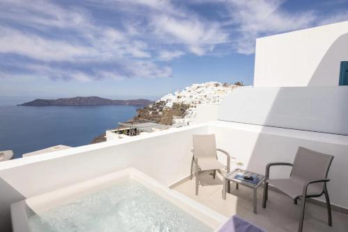 a view of the ocean from the balcony of a house at Aeifos Boutique Hotel in Imerovigli