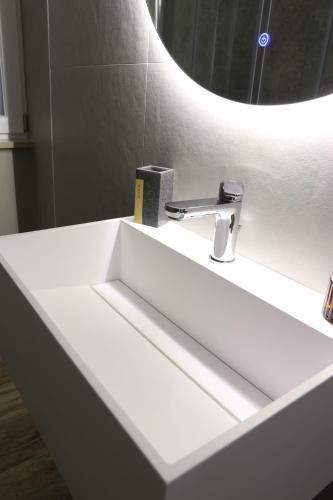 a white sink in a bathroom with a mirror at Domus Mamurra in Formia