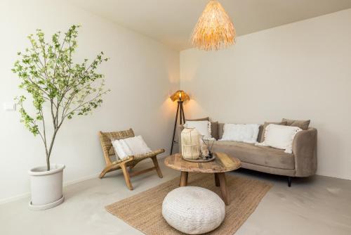 a living room with a couch and a table at Boutiquehotel Omnia in Valkenburg