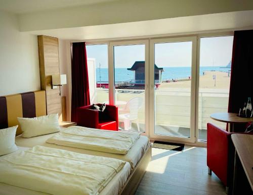 a hotel room with a bed and a view of the ocean at Seehotel in Helgoland