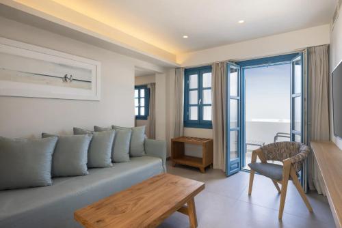a living room with a couch and a table at Aeifos Boutique Hotel in Imerovigli