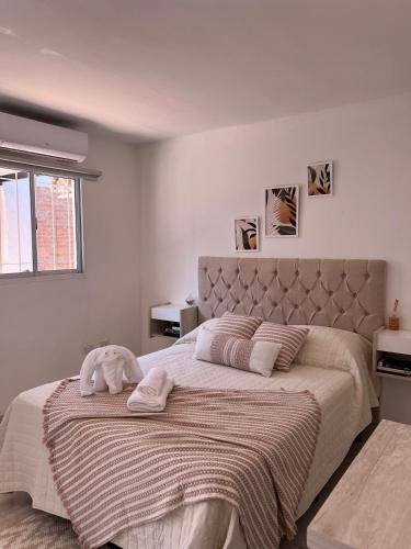 a bedroom with a large bed with a blanket at Lo de Nacho in Canning