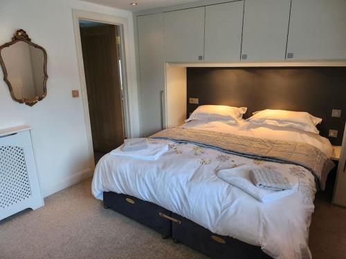 a bedroom with a large bed with white sheets and pillows at Cornwall Truro Falmouth cottage in Perranwell