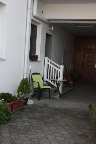 a porch with a bench and a table and a window at Ferienwohnung Birgit in Eisenstadt