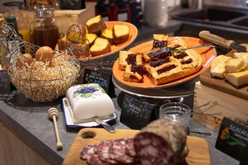 a counter with two plates of waffles and eggs and bread at Foresteria Castello di Verrazzano in Greve in Chianti