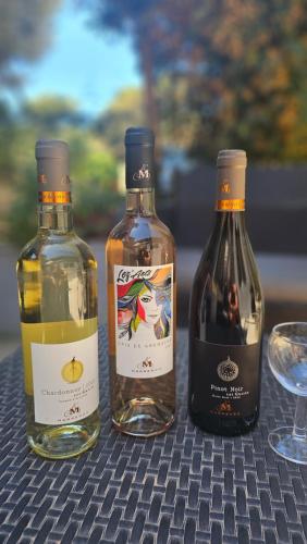 three bottles of wine sitting on top of a table at Maison Allauch La Gloire de mon Père in Allauch