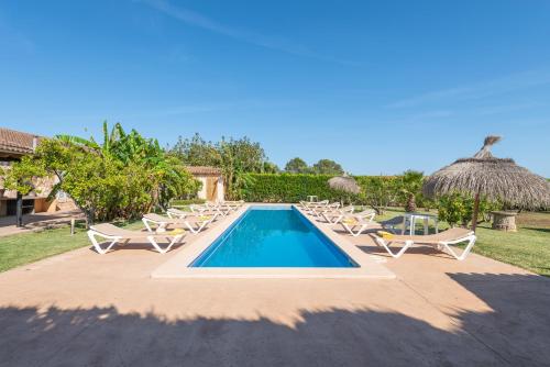 a pool with chaise lounge chairs and a resort at NEW!!!!PLAYA, PISCINA y preciosa finca Can Amer en la costa este de Mallorca in S'Illot