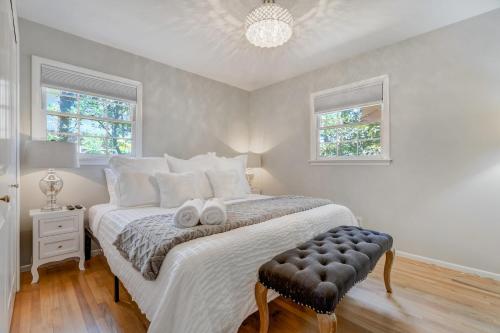 a bedroom with a bed with two white towels on it at Canopy Springs Game Room & Covered Outdoor Oasis in Colorado Springs