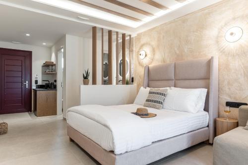 a bedroom with a white bed with a tray on it at Perla Hotel in Agios Prokopios