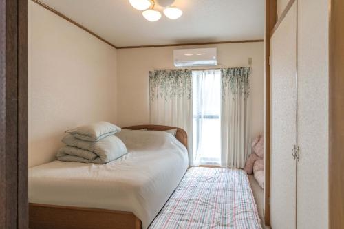 Postel nebo postele na pokoji v ubytování 易居の宿