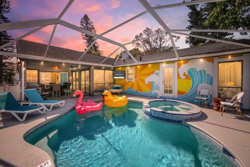 a swimming pool with two inflatables in a house at Funky Flamingo 3Kings Beach Gear Hot Tub & Pool in Bradenton