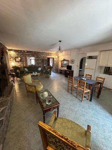 a living room with a couch and a table at Terra Mani stone rental apartments in Gerolimenas