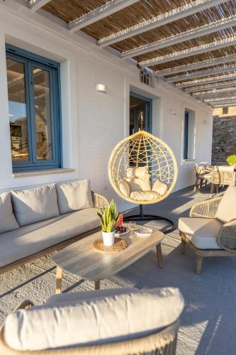 a patio with a couch and a table and chairs at Apaggio luxury villa in Kypri