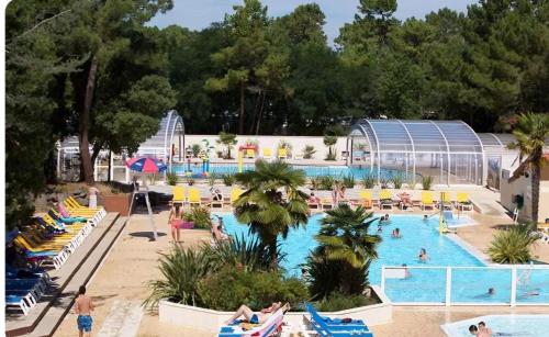 - une grande piscine avec des personnes séjournant dans un complexe dans l'établissement Camping Le Bois Dormant, à Saint-Jean-de-Monts