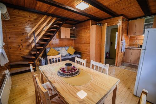 a kitchen and dining room with a table in a cabin at Holiday Home Brina 69 in Čatež ob Savi