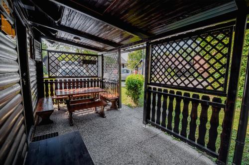 a screened porch with a bench and a fence at Holiday Home Brina 69 in Čatež ob Savi