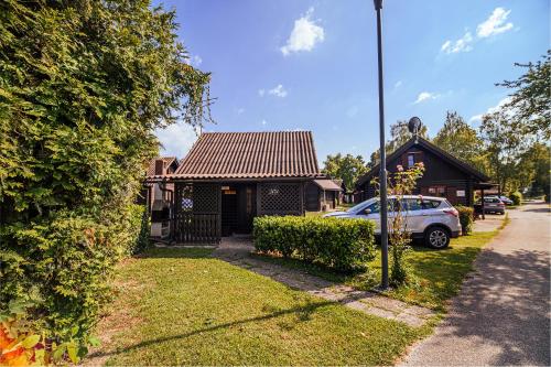 a house with a car parked in front of it at Holiday Home Brina 69 in Čatež ob Savi