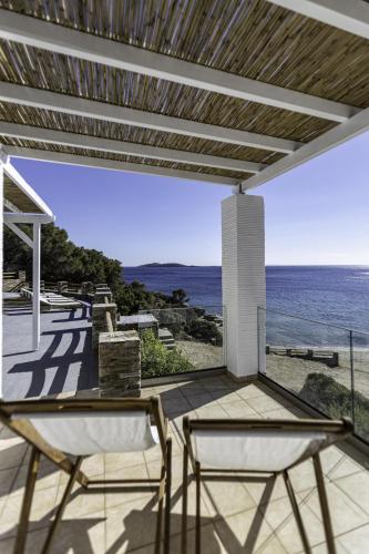 a patio with two chairs and a view of the ocean at Apaggio luxury villa in Kypri
