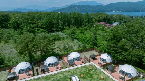 an overhead view of three domes in a garden at Gramercy Village 山中湖 Glamping &Sauna in Yamanakako