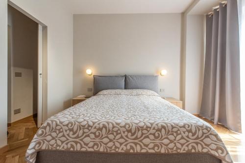 a bedroom with a large bed and two night stands at MiraFlora in Turin