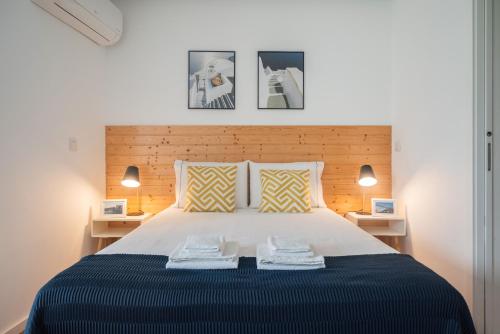 a bedroom with a large bed with two night stands at Sunflower Luxury Loft w AC Downtown and Metro in Porto