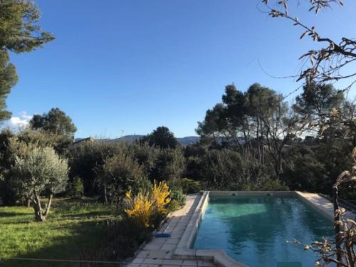 une piscine au milieu d'une cour dans l'établissement Belle maison piscine dans cadre verdoyant Vaucluse à 45min d'Aix et 55min de Marseille, à Puget