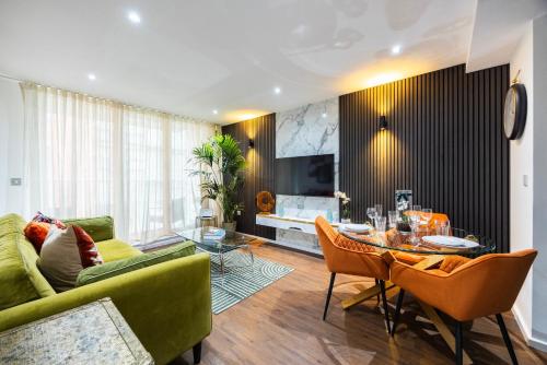 a living room with a green couch and a table at Austin David Executive ExCeL in London