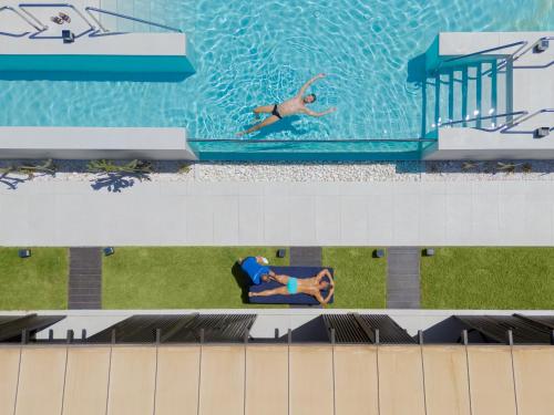 two people swimming in a pool on a cruise ship at Fahana - Gay Men Only in Playa del Ingles