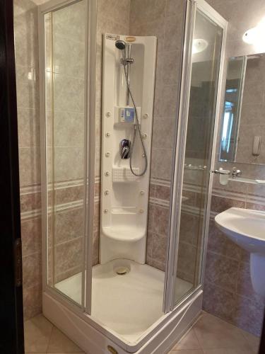 a shower stall in a bathroom with a sink at ХОТЕЛ ВИЛА Мая in Pleven