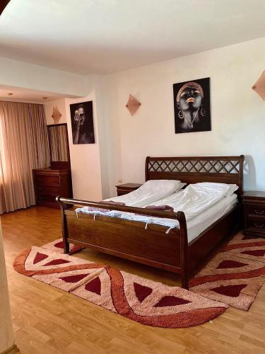 a bedroom with a bed and a rug on the floor at ХОТЕЛ ВИЛА Мая in Pleven