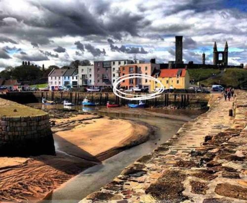 a view of a river with buildings in the background at Beach Front Apt 2 Bedrooms 2 Bathrooms St Andrews in Fife