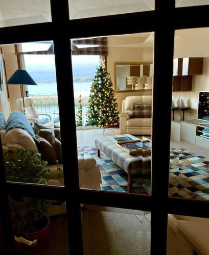 a living room with a christmas tree and a couch at Beach Front Apt 2 Bedrooms 2 Bathrooms St Andrews in Fife