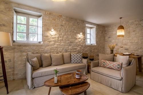 a living room with a couch and a table at BASSA MAINA Villas & Suites in Areopolis