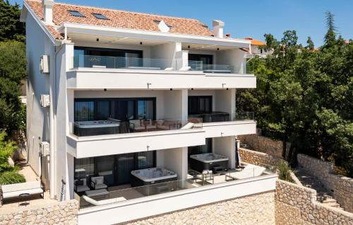 a large white building with a wall at Gorgeous Apartment In Novi Vinodolski in Novi Vinodolski