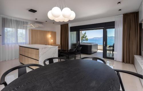 a kitchen and dining room with a table and chairs at Beautiful Apartment In Novi Vinodolski in Novi Vinodolski
