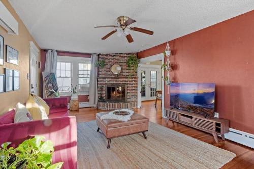 a living room with a ceiling fan and a large tv at AC 6BR 2BA Quiet Retreat Central Location in Atlantic City