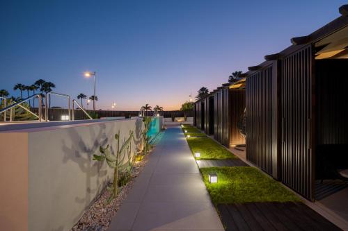 a walkway with lights on the side of a building at Fahana - Gay Men Only in Playa del Ingles