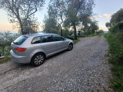 a silver car parked on the side of a dirt road at Terrazza Oneto in Crocetta