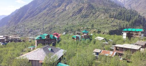 a group of houses on a hill with a mountain at Majestic House and Bonkers on the go Café in Kalgha