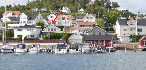 a group of boats docked in a harbor with houses at Ved sjøen, Husvik- Tønsberg, 2 hus! in Tønsberg