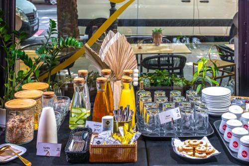 a table topped with bottles and dishes of food at Andrassy Thai Hotel in Budapest