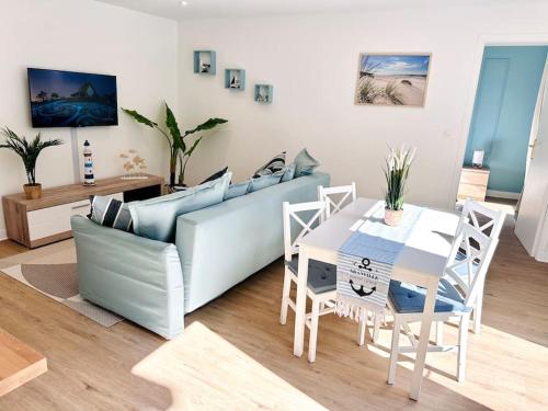 un salon avec un canapé et une table dans l'établissement Appartement Au Cœur de Granville, à Granville