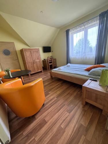 a room with a bed and a table and a window at BedRooms 3 Maja 15A in Łódź