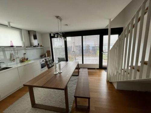 a kitchen with a wooden table in a room at Newly Renovated Cheerful Cottage in Dürnstein in Dürnstein