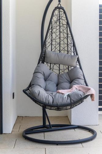 a black swing chair with pillows in a room at Vila Aris in Kostrena