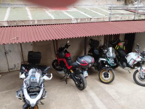 a group of motorcycles parked in front of a building at B&B Bassu in Bosa