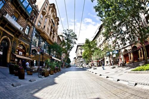 une rue vide dans une ville avec des bâtiments dans l'établissement Hello Downtown Apartment - Broadway, à Budapest